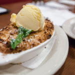 Fresh peach cobbler with vanilla ice cream